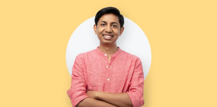 a man smiling with folding hands